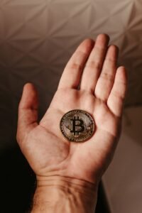 close up of bitcoin crypto currency coin on hand