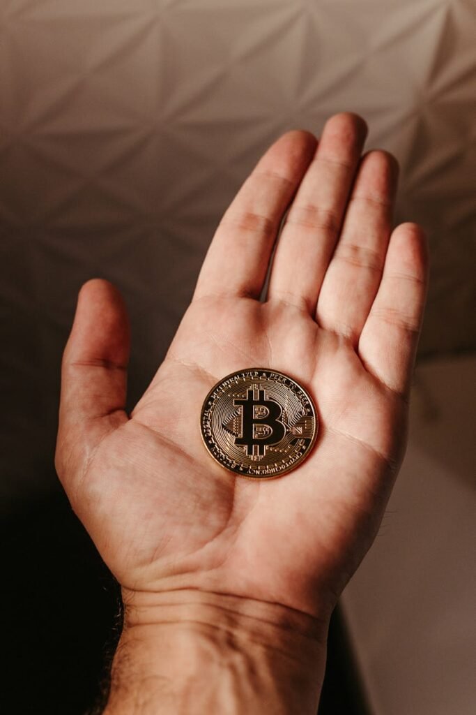 close up of bitcoin crypto currency coin on hand